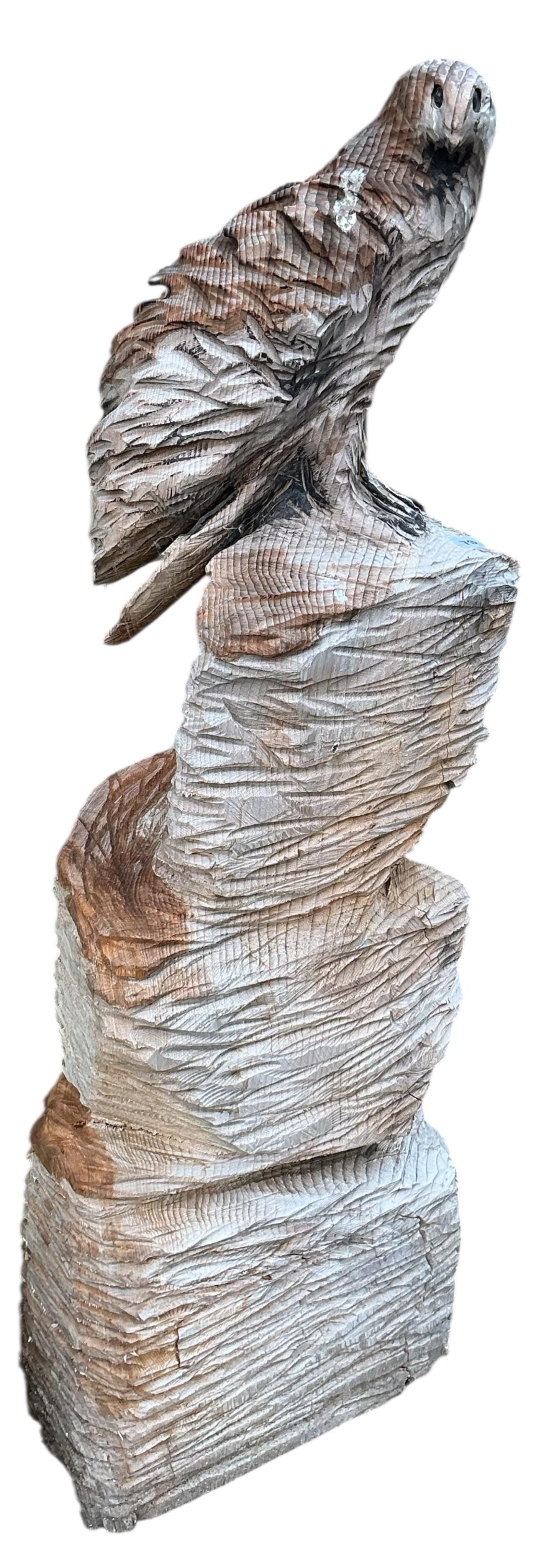 A chainsaw carving of an eagle on an outcrop, height 127cm